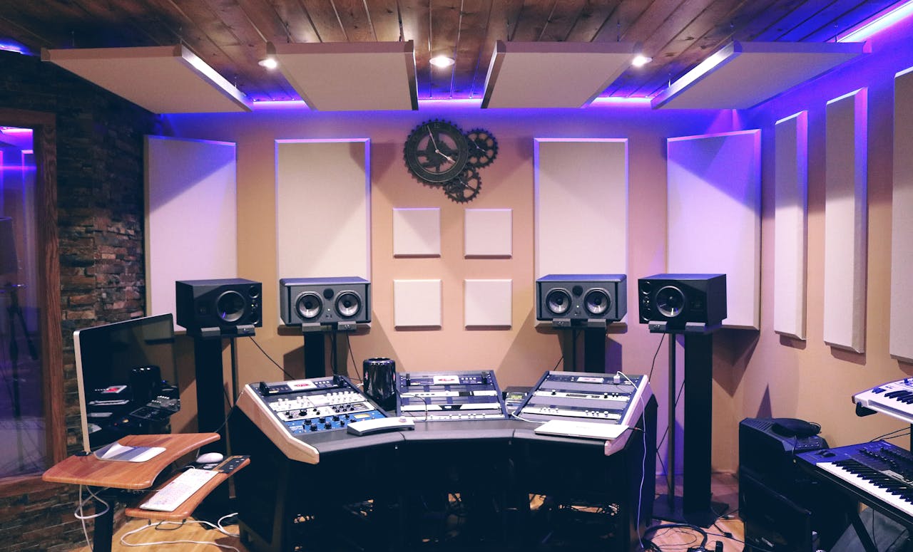 hero-img-01 Modern recording studio with high-tech audio equipment and stylish lighting.